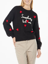 Woman boxy shape soft sweater with Somebody to Love embroidery and crochet hearts patch