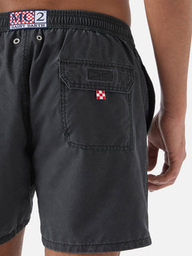 Patmos swim shorts in black with used effect and logo embroidery