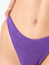 Woman purple crinkle cheeky swim briefs