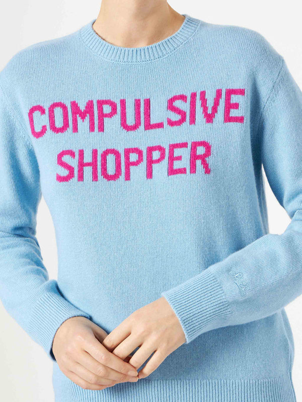 Woman crewneck light blue sweater with Compulsive Shopper jacquard